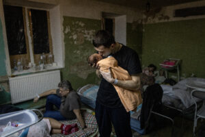 KYIV, UKRAINE - MARCH 02: A man holds a newborn child in the bomb shelter of a maternity hospital on March 02, 2022 in Kyiv, Ukraine. Russian forces continued their advance on the Ukrainian capital for the seventh day as the country's invasion of its western neighbour goes on. Intense battles are also being waged over Ukraine's other major cities.